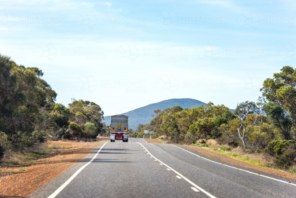 road train travelling on an open empty road - Australian Stock Image