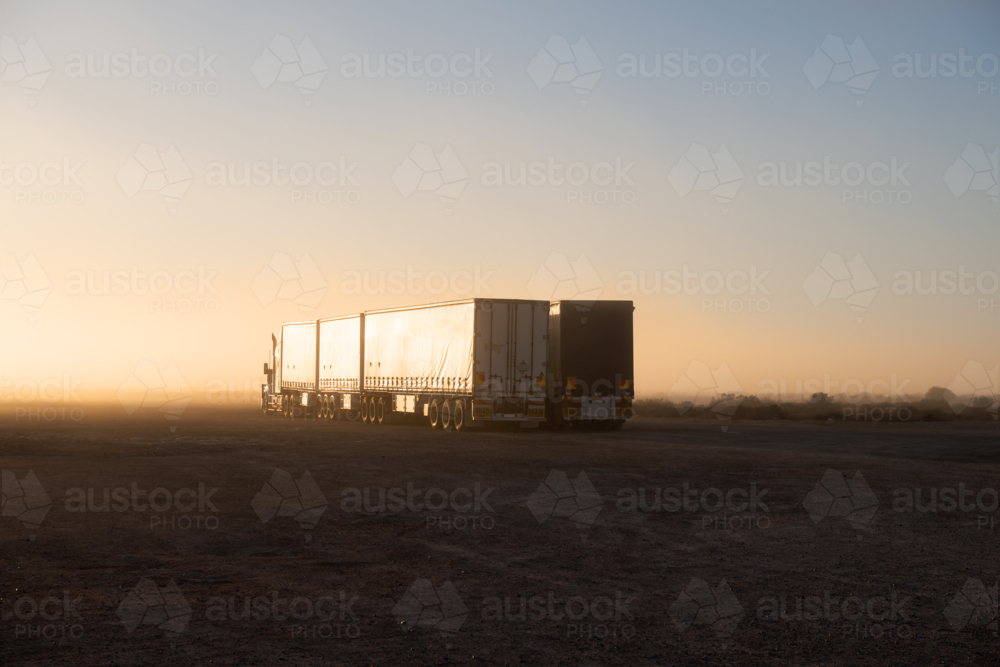 Road Train trucks parked at roadhouse shrouded in fog, Eyre Highway, South Australia - Australian Stock Image
