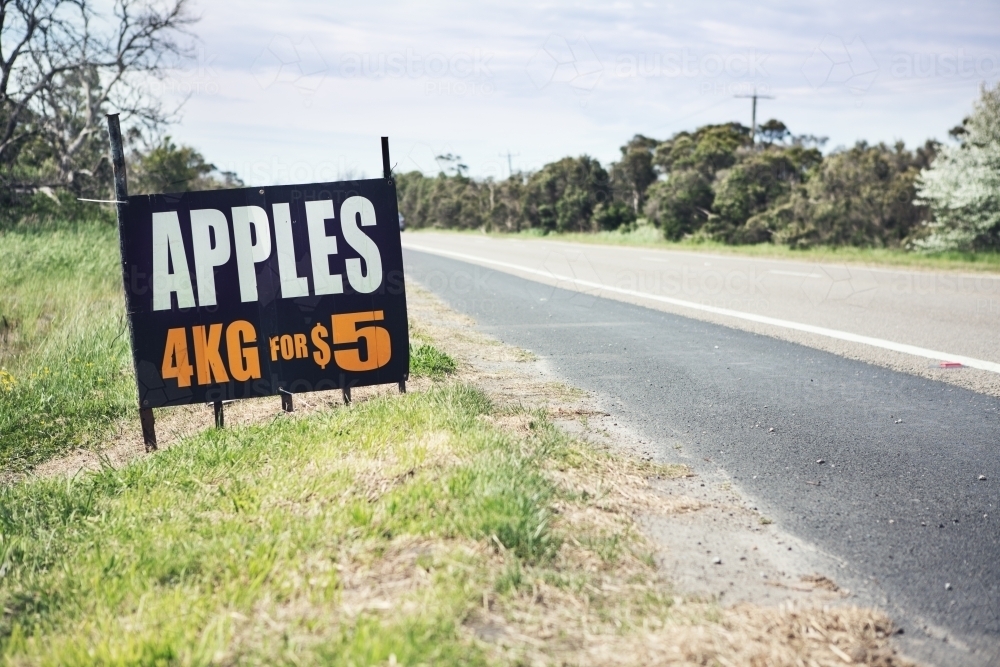 Roadside sign advertising fresh apples for sale ahead horizontal - Australian Stock Image