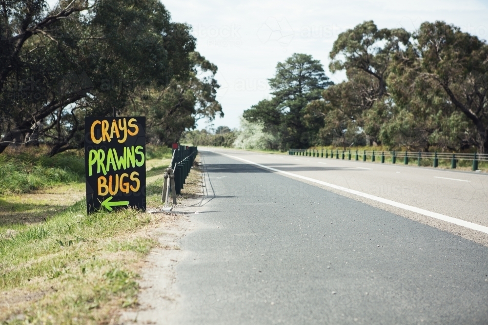 Roadside sign advertising fresh crays prawns and bugs for sale horizontal - Australian Stock Image
