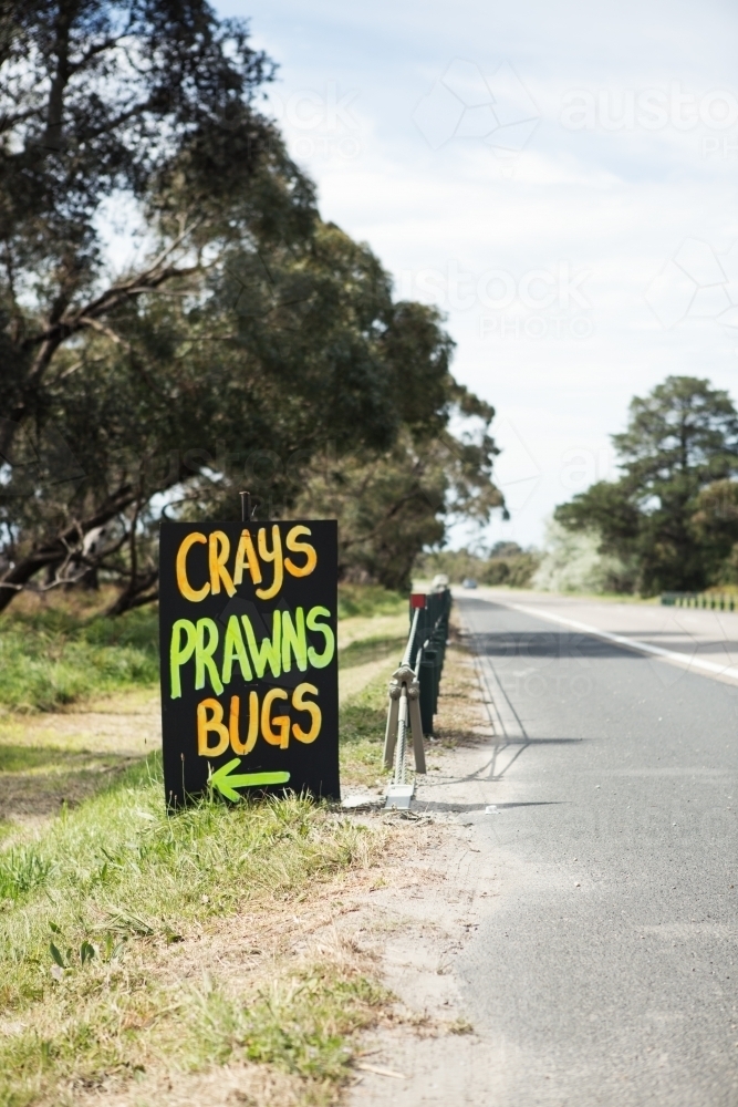 Roadside sign advertising fresh crays prawns and bugs for sale vertical - Australian Stock Image