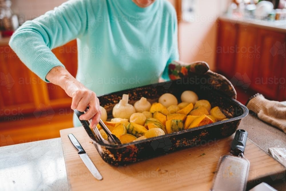 Roast vegetables being served - Australian Stock Image