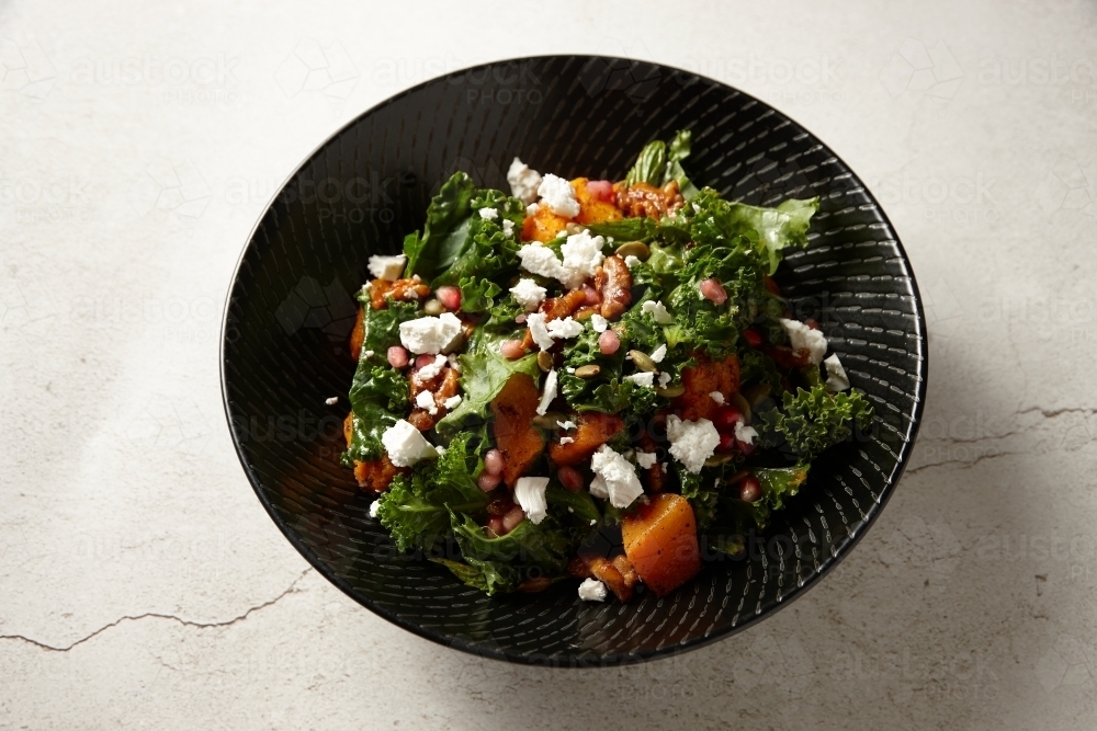 Roasted pumpkin salad in bowl - Australian Stock Image