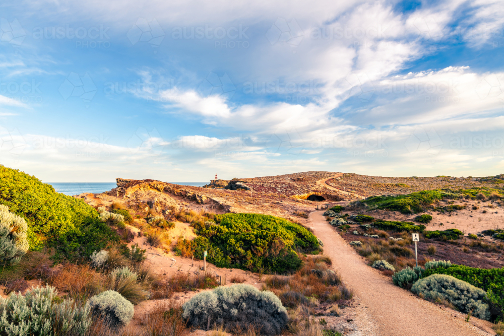 Robe Coastal Walk with the Obelisk viewed along the rugged Limestone Coast with the ocean during sun - Australian Stock Image