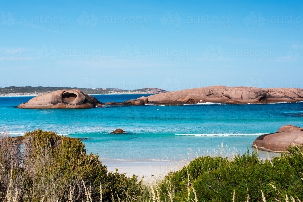 rock islands in sheltered bay - Australian Stock Image