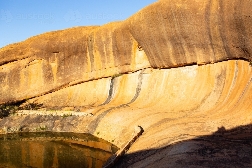Rock pool and wave formation at Beringbooding Rock - Australian Stock Image