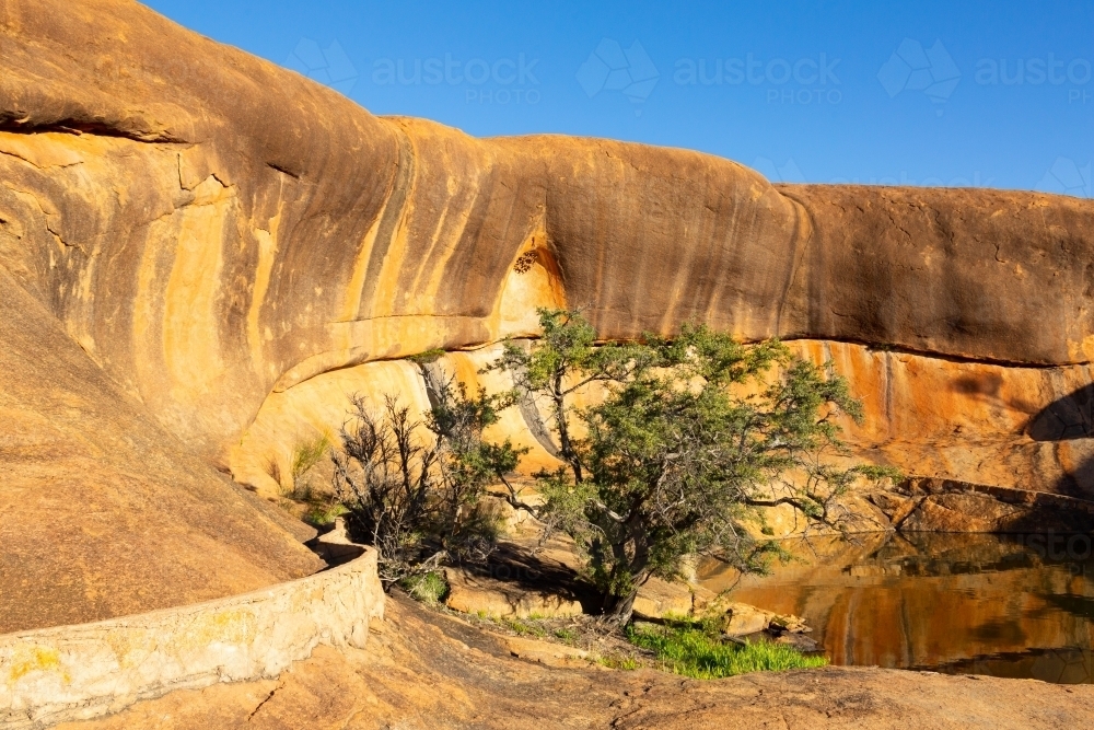 Rock pool and wave formation at Beringbooding Rock - Australian Stock Image