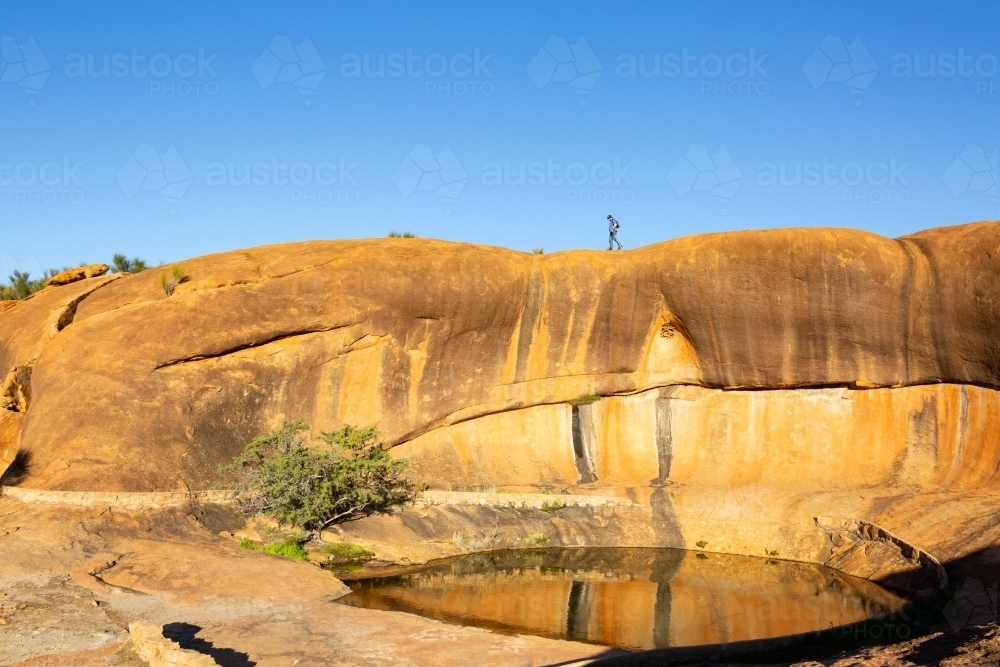 Rock pool and wave formation at Beringbooding Rock - Australian Stock Image