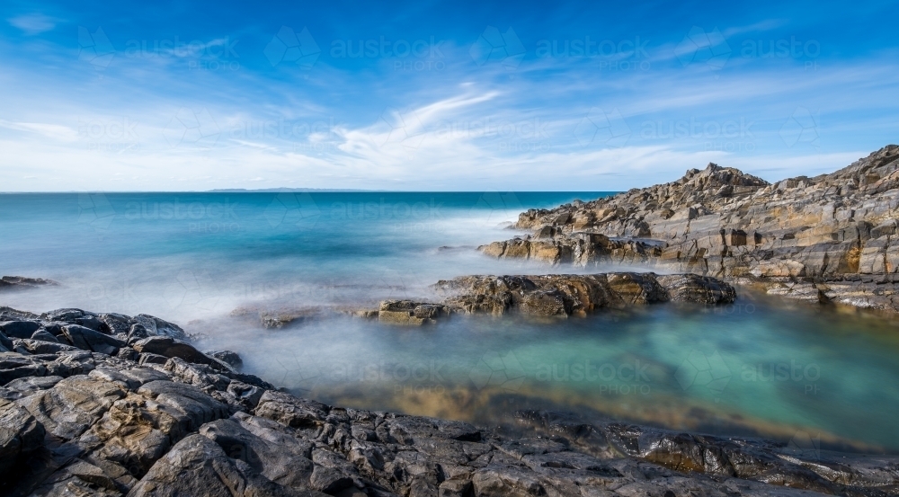 Rock pools overlooking blue ocean - Australian Stock Image