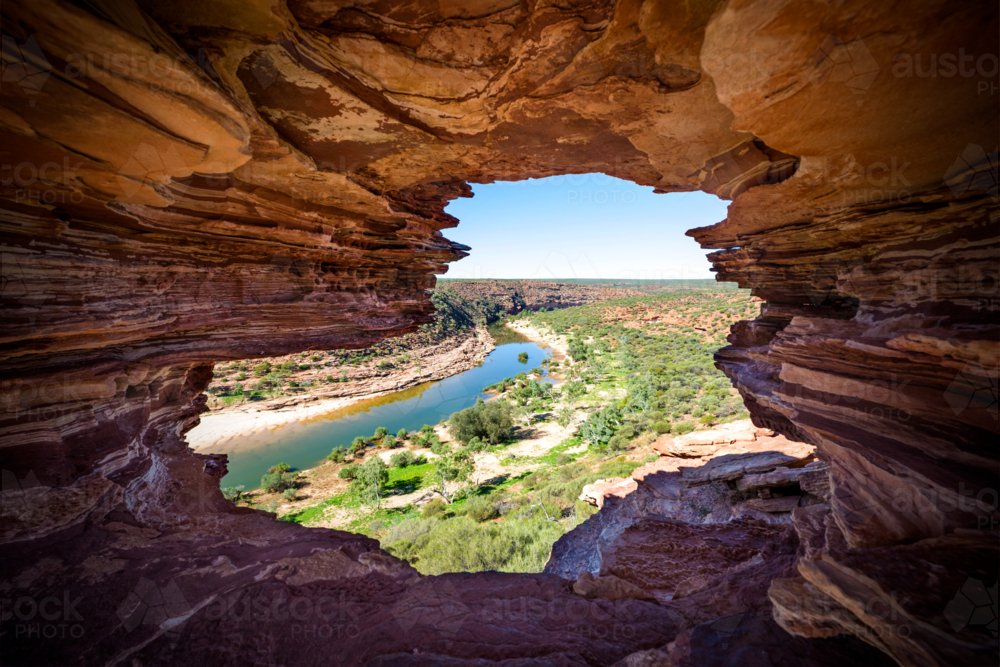 Rock window framing a winding river and rugged valley - Australian Stock Image