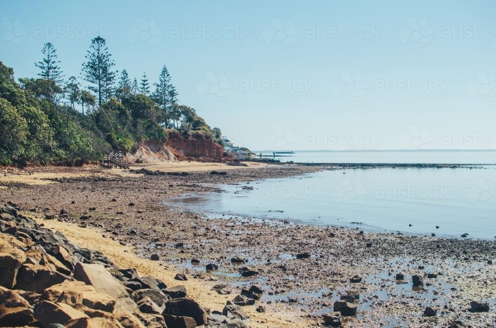 Rocky beach in Brisbane at midday - Australian Stock Image