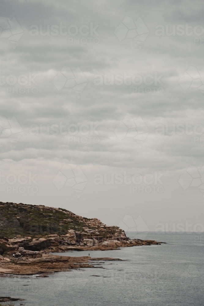 Rocky headland and waters edge at Boora Point, Malabar. - Australian Stock Image