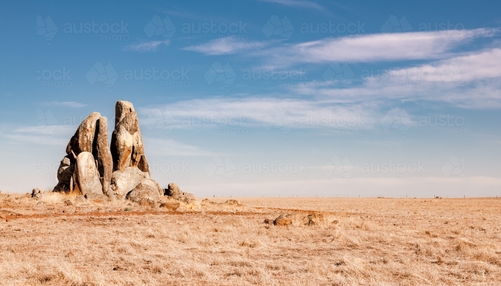 Rocky outcrop in harvested wheat field - Australian Stock Image