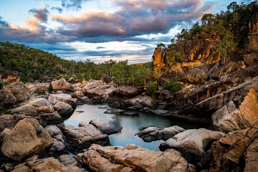 Rocky river and waterhole at sunset - Australian Stock Image