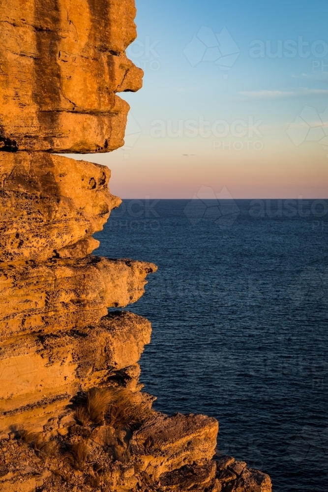 Rocky sea cliffs at sunset - Australian Stock Image
