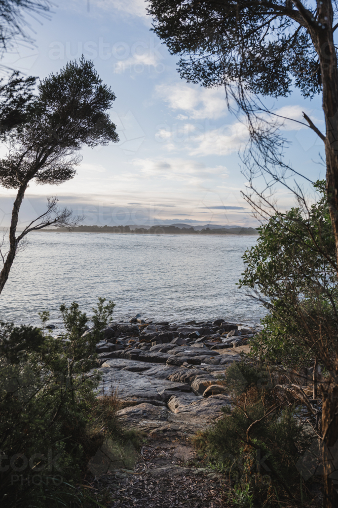rocky shoreline at sunrise : Austockphoto rocky shoreline at sunrise - Australian Stock Image