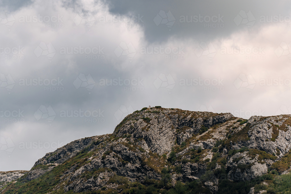 Rocky terrain mountain peak with an overcast sky - Australian Stock Image