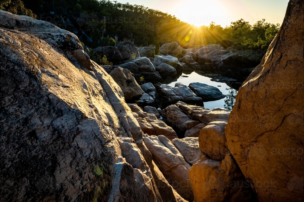 rocky waterhole and river at sunrise - Australian Stock Image