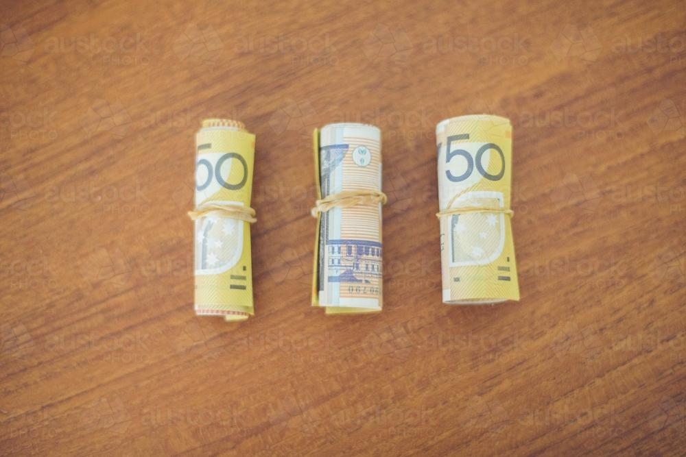 Rolled 50 dollar notes on the table - Australian Stock Image