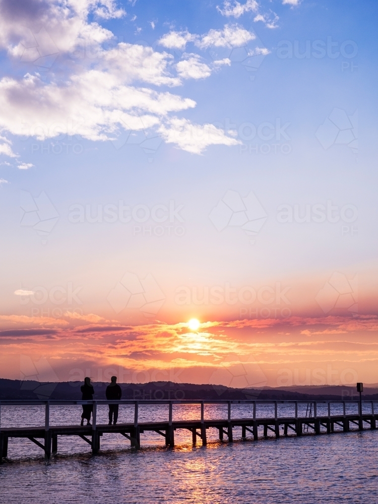 Romantic Couple walking along Long Jetty - Australian Stock Image