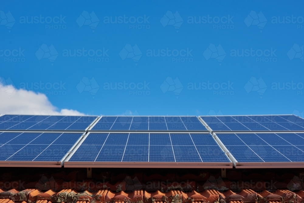 Rooftop solar panels under blue sky - Australian Stock Image