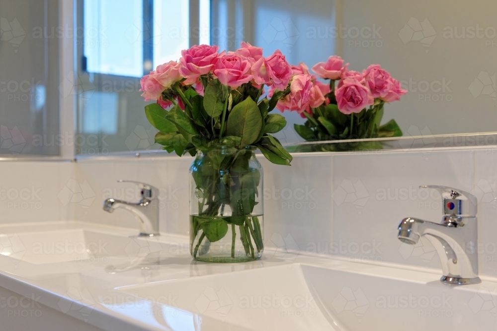Image of Roses flower arrangement in a double basin bathroom ensuite