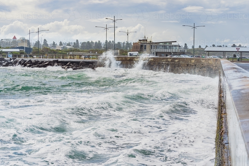 Rough ocean and big sea waves battering a coastal break water - Australian Stock Image
