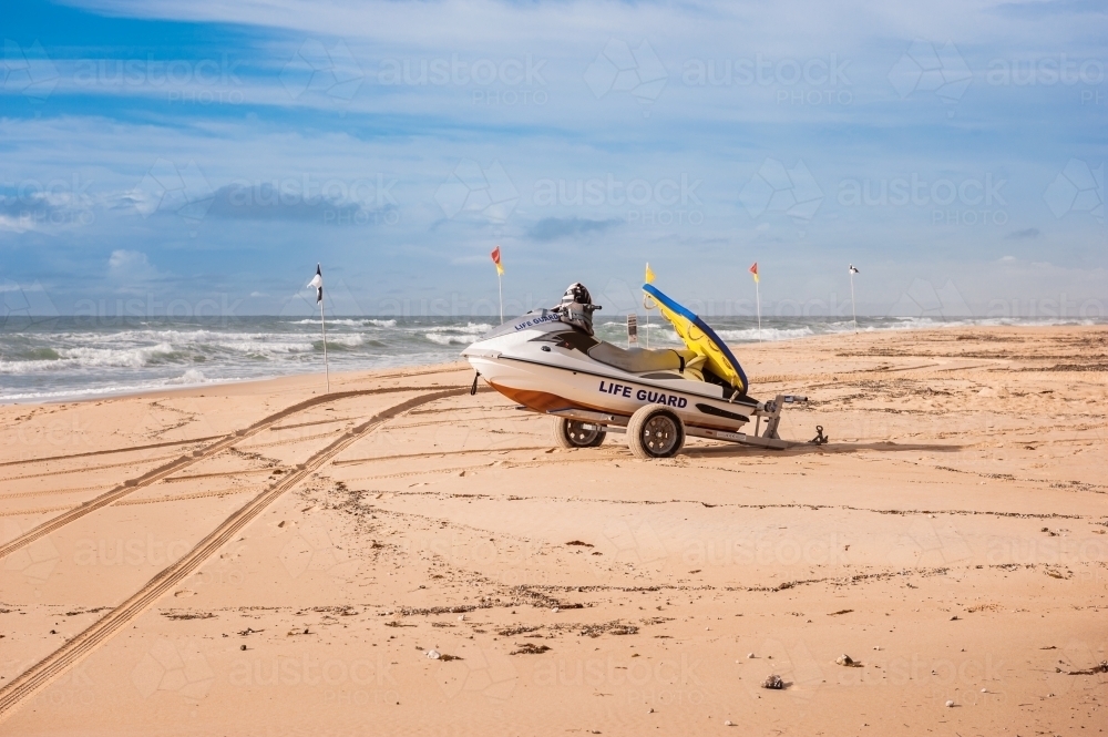 Rough seas at Sunshine Beach, with life guard vessel on sand - Australian Stock Image