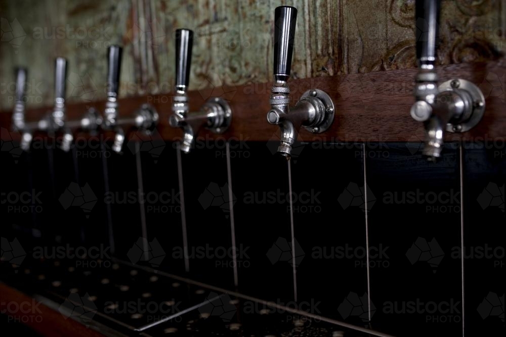 Row of beer taps at craft beer pub - Australian Stock Image