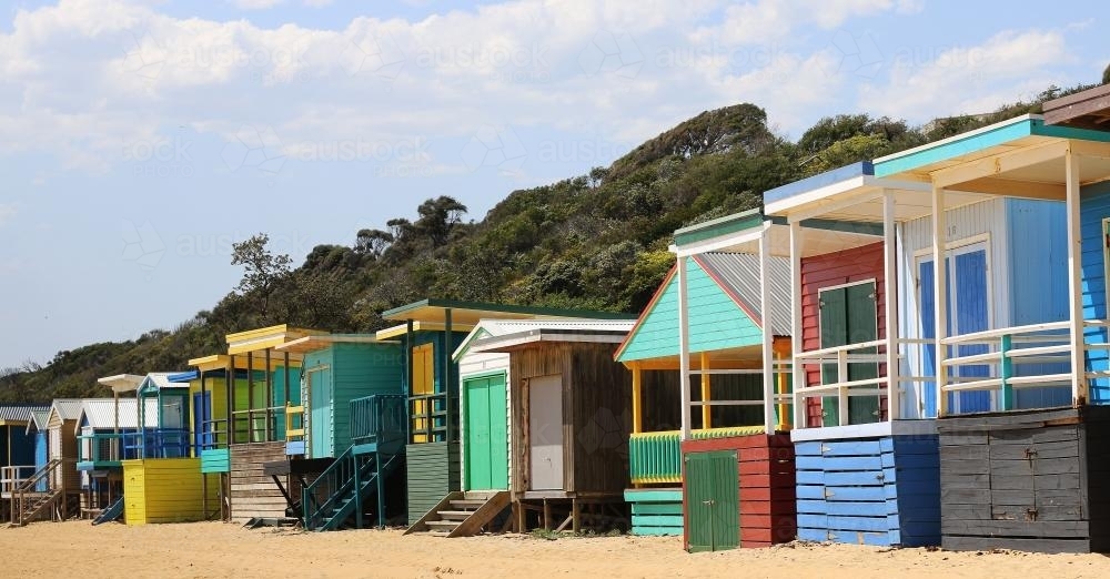 Row of bright beach boxes on a sunny summers day - Australian Stock Image