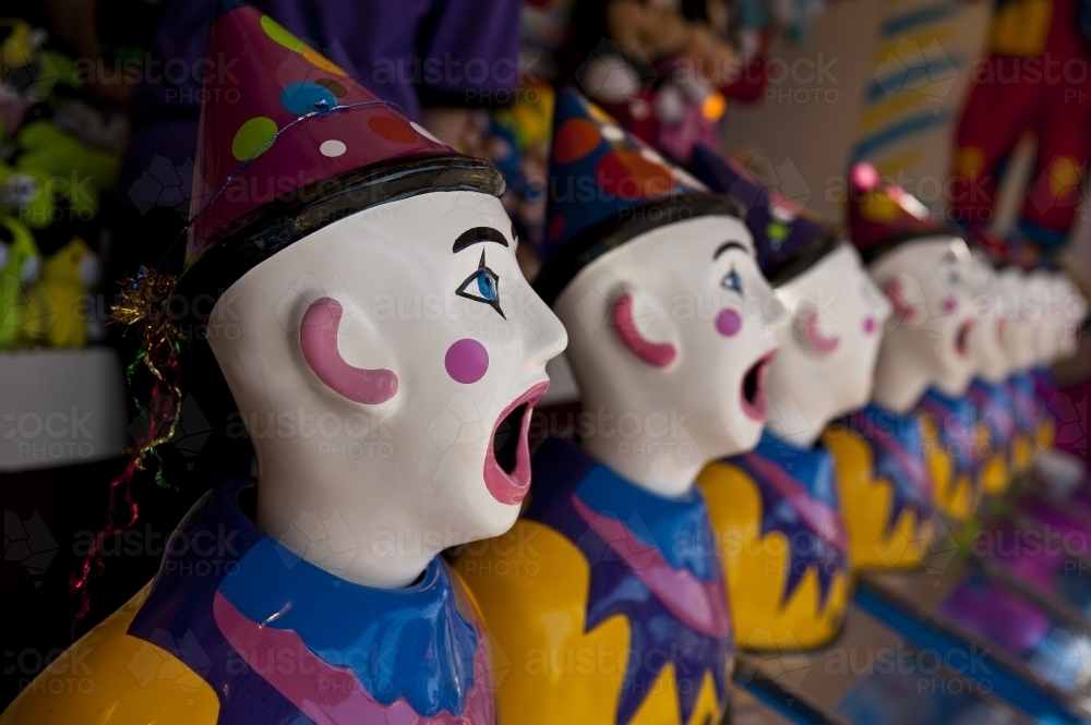 Row of clown heads, turning away - Australian Stock Image