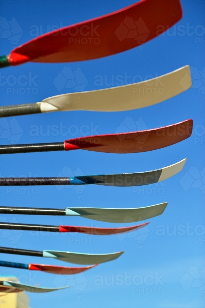 Row of colourful oars and blue sky - Australian Stock Image
