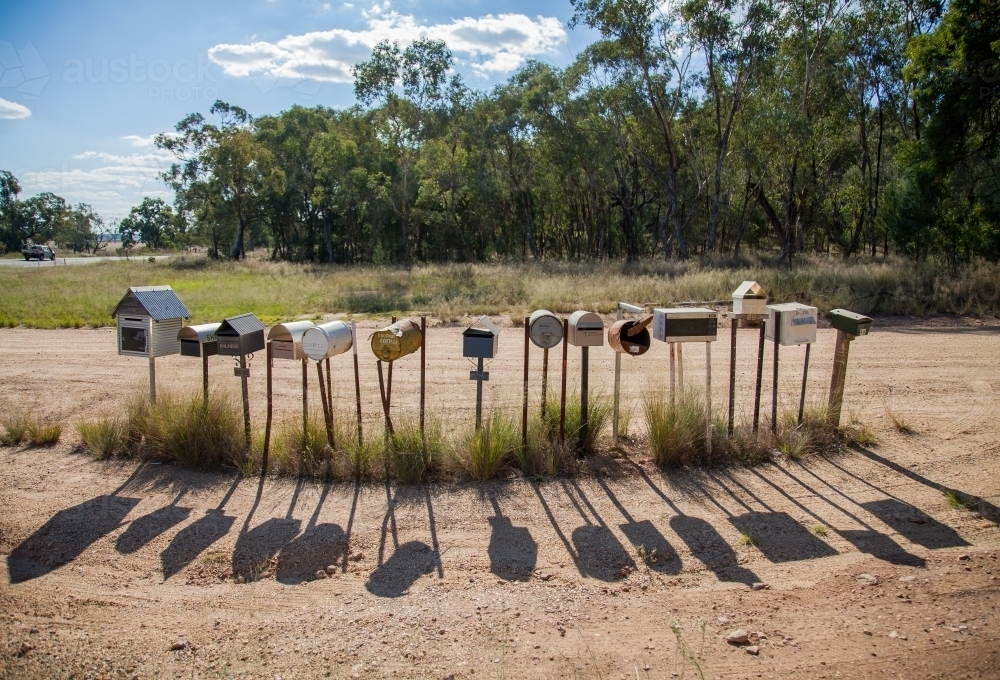 Image of Row of country mailboxes on rural dirt road Austockphoto