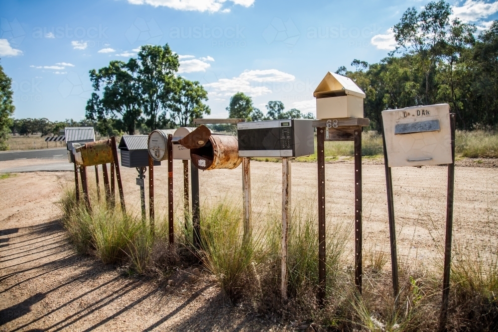 Image of Row of country mailboxes on rural dirt road Austockphoto