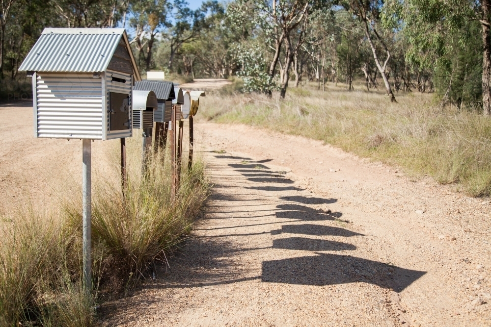 Row of country mailboxes on rural dirt road - Australian Stock Image