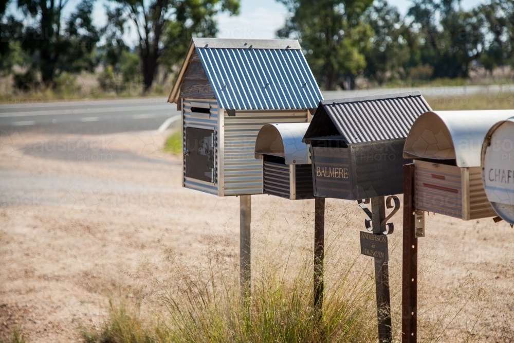 Row of country mailboxes on rural dirt road - Australian Stock Image