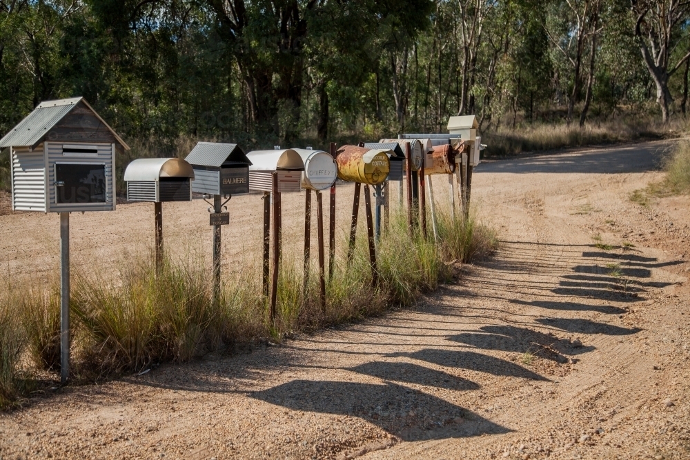 Row of country mailboxes on rural dirt road - Australian Stock Image