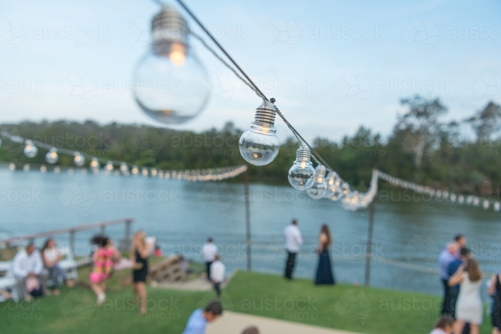 Row of lights at outdoor party by Parramatta river - Australian Stock Image