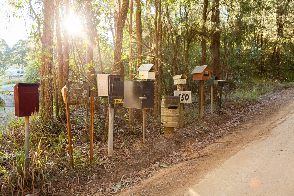 Row of mailboxes beside gravel country road - Australian Stock Image