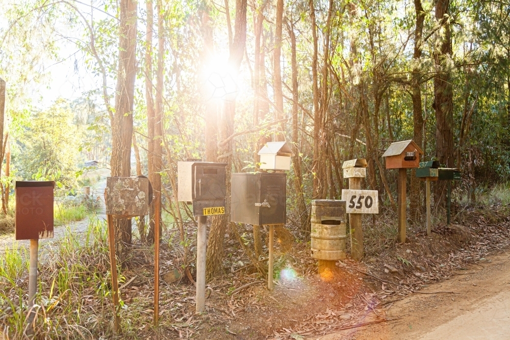 Row of mailboxes beside gravel country road - Australian Stock Image