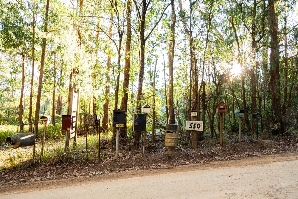 Row of mailboxes beside gravel country road - Australian Stock Image