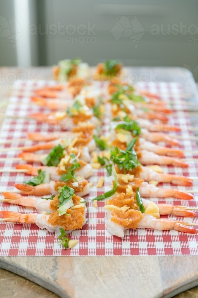 Row of prawn platter on chopping board ready to be served - Australian Stock Image