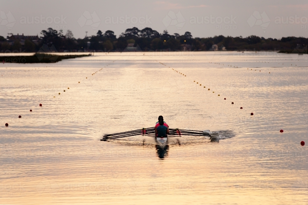 Rowing training on a lake in the evening - Australian Stock Image