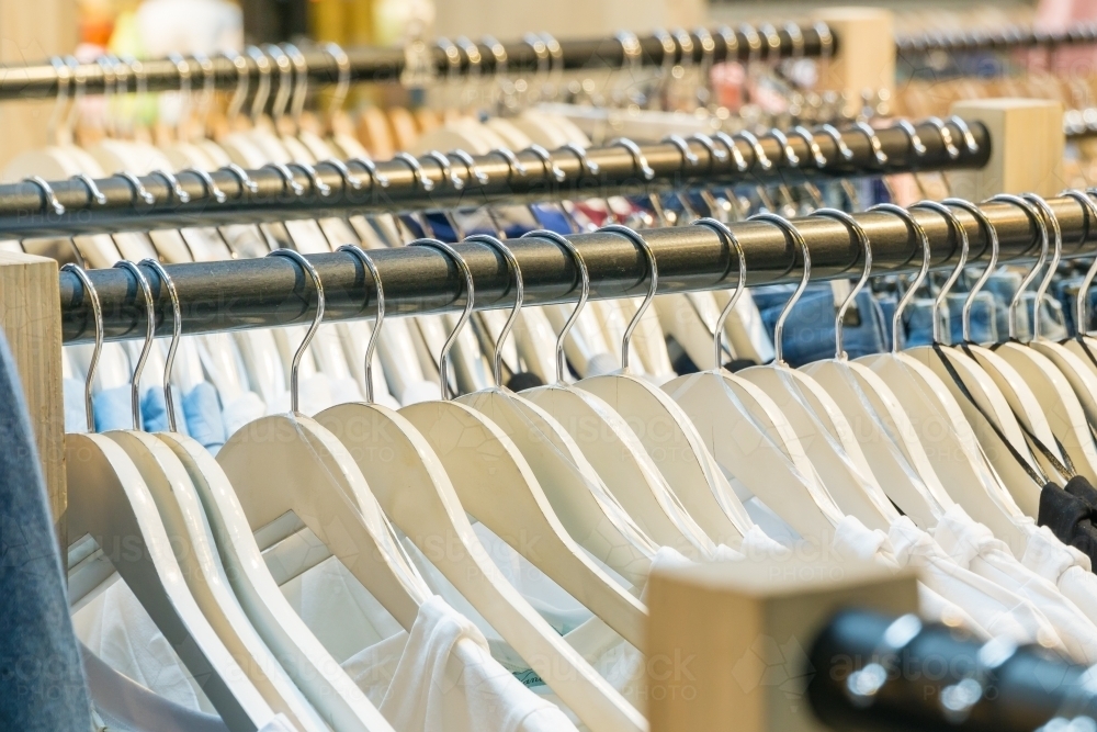 Rows of clothes racks full of clothes on hangers - Australian Stock Image