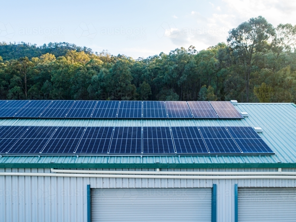 Rows of solar panels installed on house shed roof in rural area - Australian Stock Image