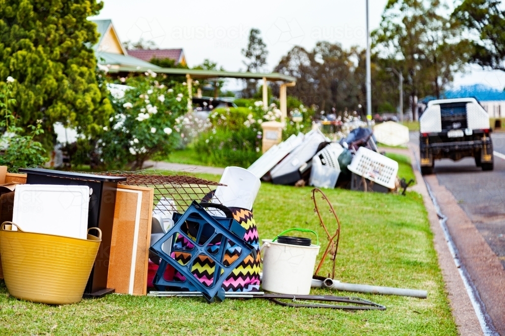Rubbish and junk on front lawn out for council bulk waste cleanup - Australian Stock Image