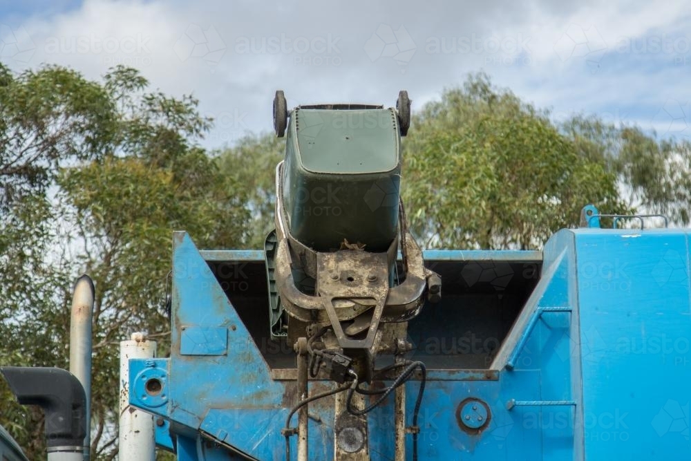 Rubbish being tipped into a garbage truck - Australian Stock Image