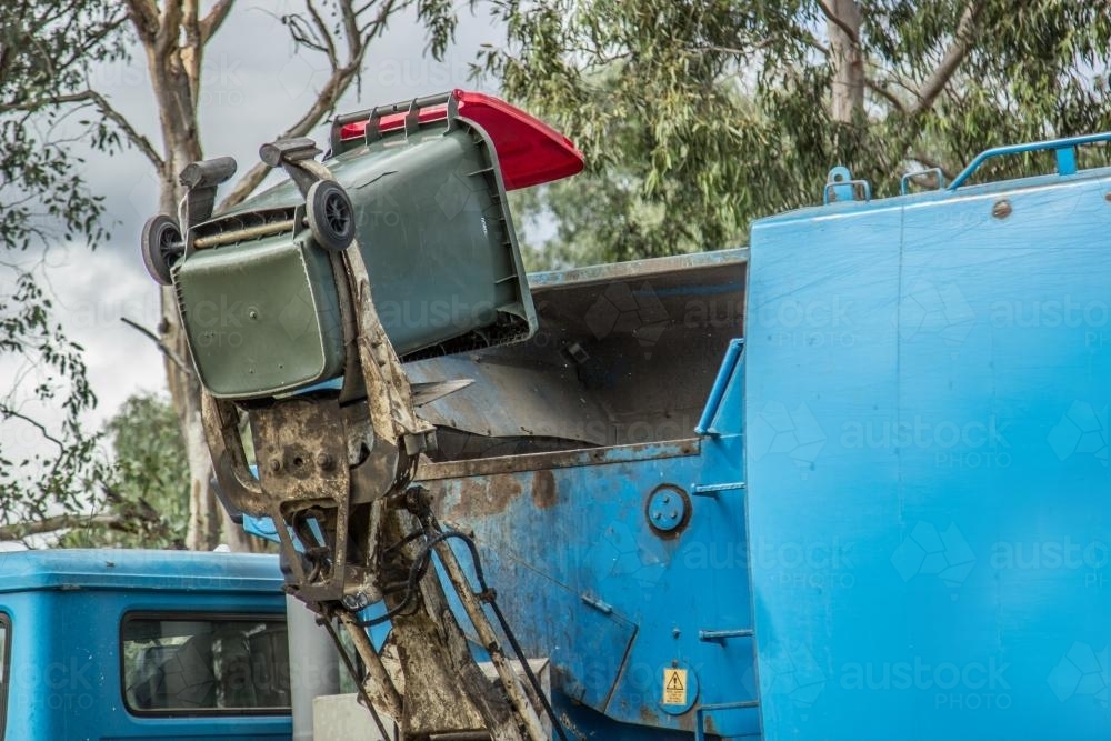 Image of Rubbish being tipped into a garbage truck Austockphoto