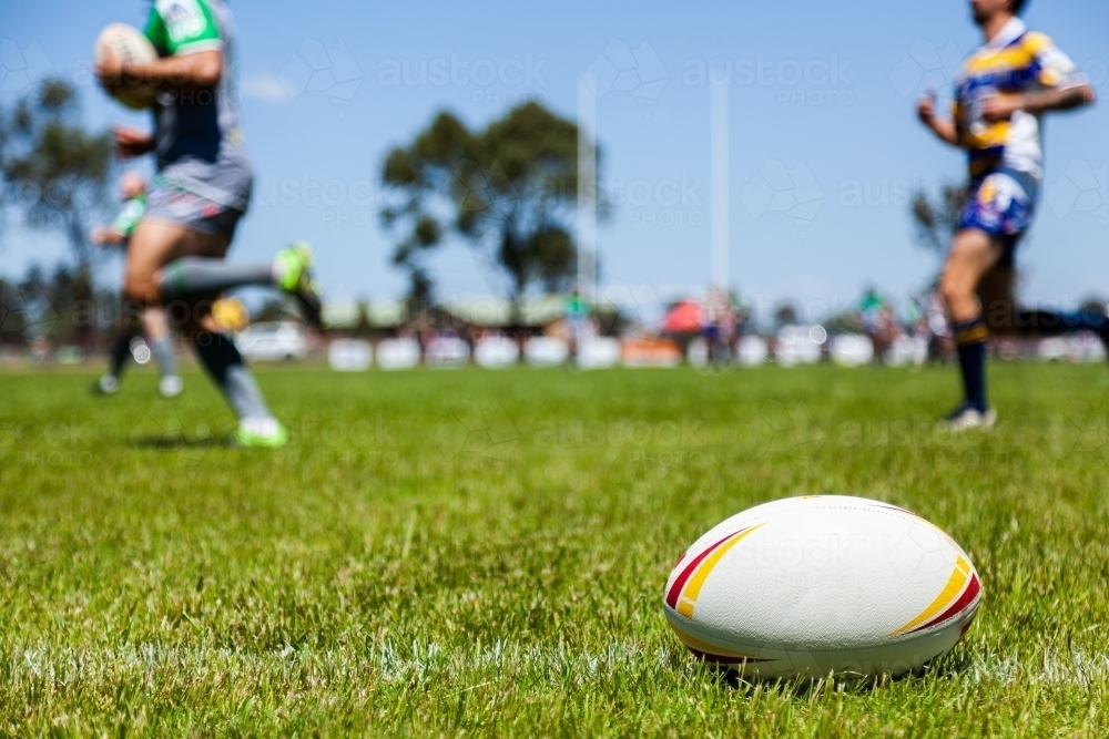 Image of Rugby ball on with edge of the playing field during a game