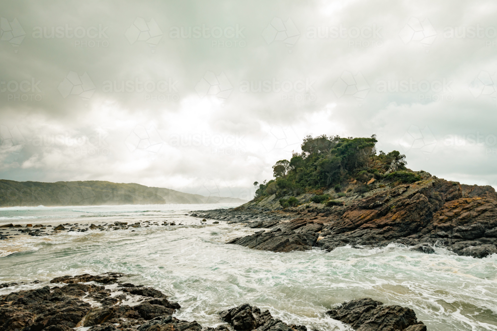 Image of Rugged coastline with crashing waves against rocky shore under ...